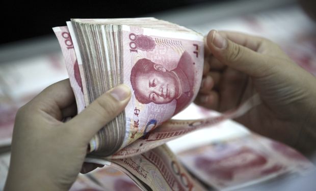 A bank clerk counts renminbi banknotes in a bank branch in Huaibei in central China (Photo: AP) A bank clerk counts renminbi banknotes in a bank branch in Huaibei in central China (Photo: AP)